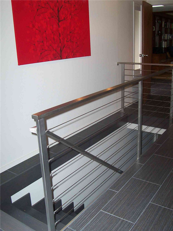 The options of railing selections are endless. For a contemporary look, an aluminum cable railing system was installed along with the unique 12
