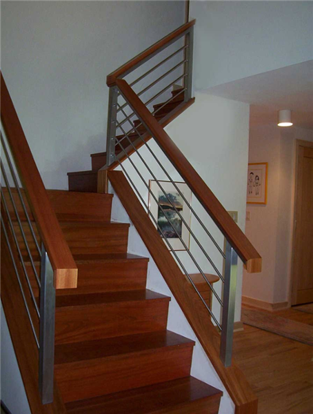 This contemporary staircase was built from Brazilian cherry. Custom crafted aluminum handrails accentuate the clean modern styling.