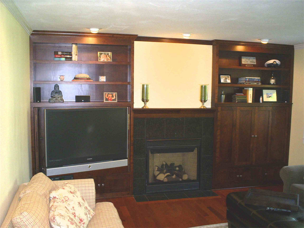 Entertainment centers can be built to meet the needs of the owner. This center was built to house a large LCD television. The LCD was mounted to a pullout swivel arm so that it can be pulled out for viewing and recessed in when not in use. Fold in doors were installed to slide out and conceal the TV for a completely hidden view. The size of the shelving and cabinets in the center was determined by what it would store.