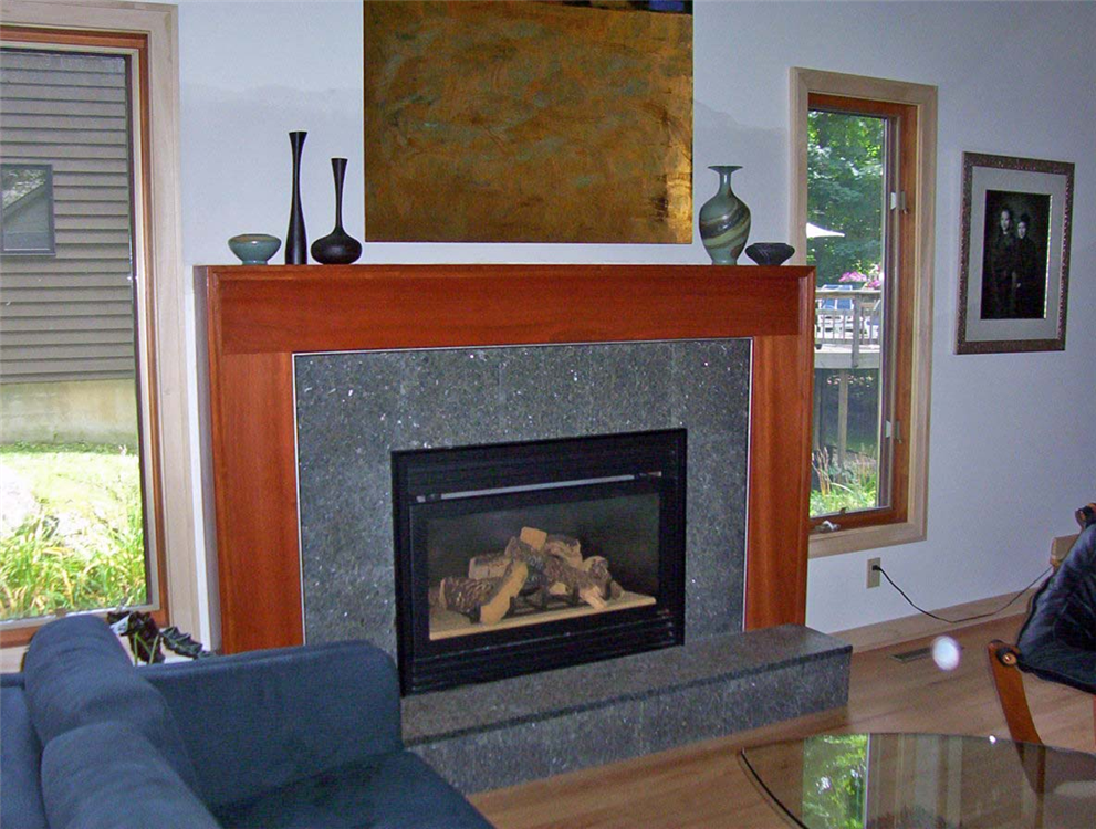 The stained wood and granite tile on this surround give this gas fireplace a completely new appearance.