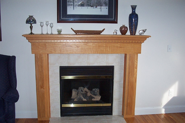 For an updated look, a custom oak mantle and new tile surround was installed for this gas fireplace.
