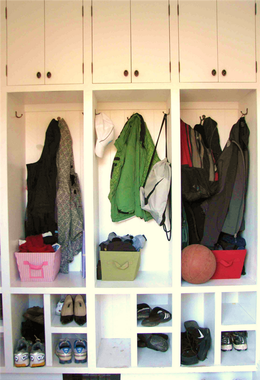Built-in cubbies provide storage for items such as coats, shoes and backpacks for the entire family in this re-designed mudroom.