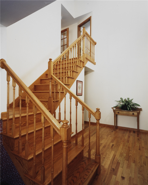 These finished oak stairs and railing give access to the new 2nd story addition on this home.