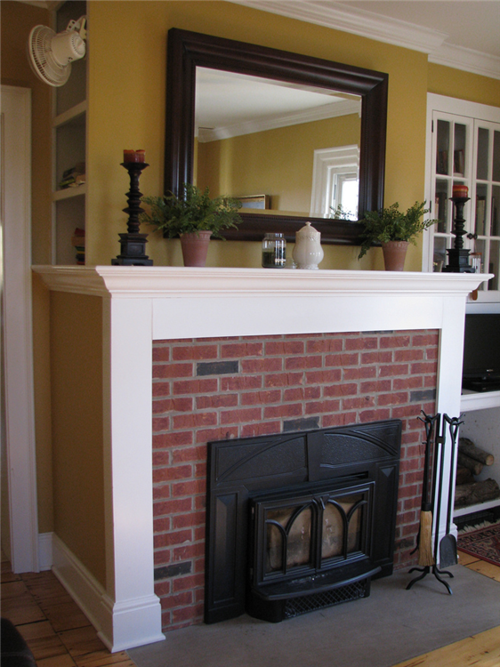 This custom painted mantle made this old brick fireplace look new again.