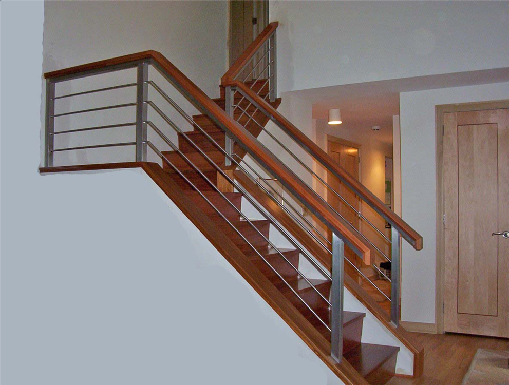 This custom handrail design uses both stainless steel and cherry to create a clean modern look.