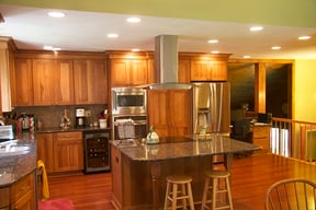 kitchen-with-island-cooktop-and-vent-hood