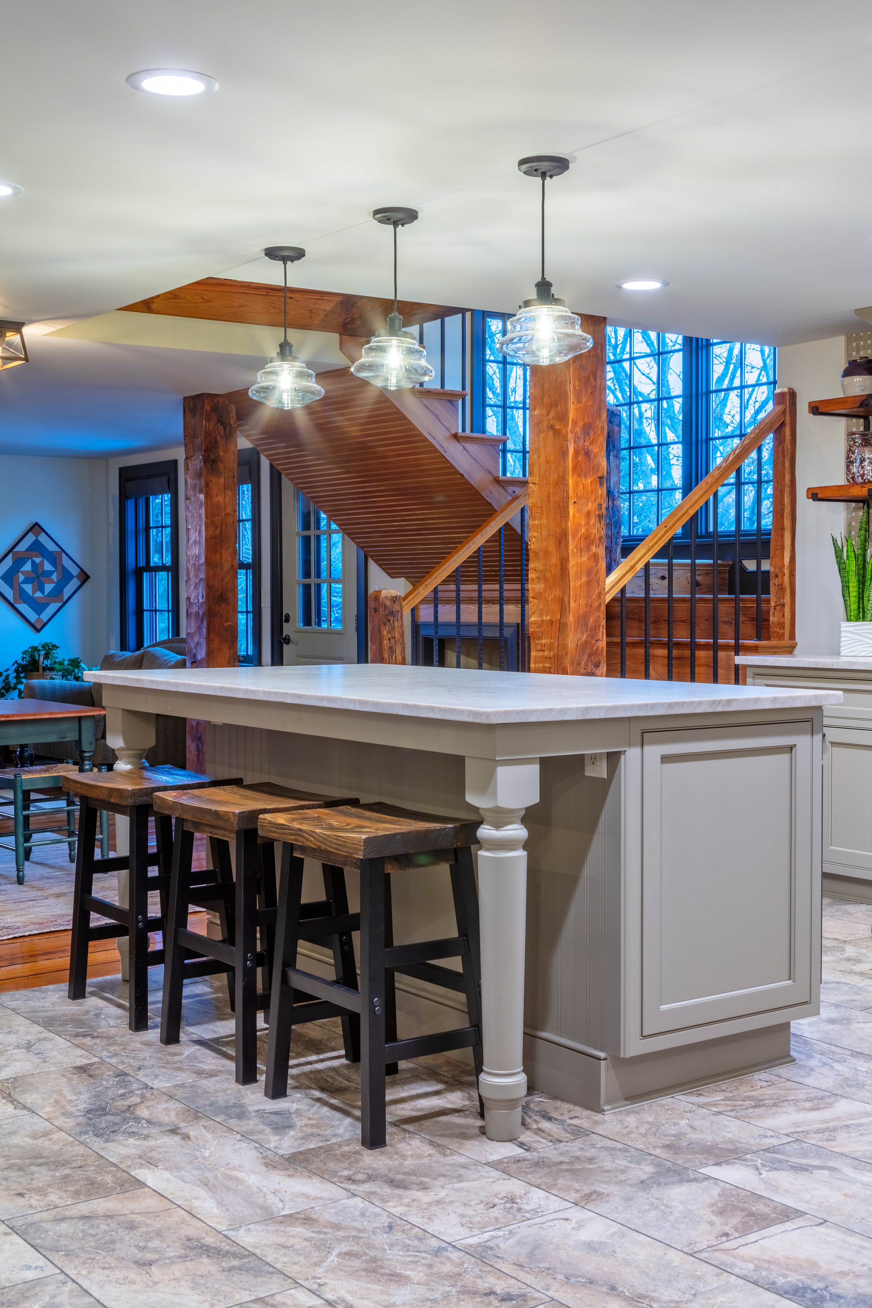 A large kitchen island with seating and pendant lighting above.