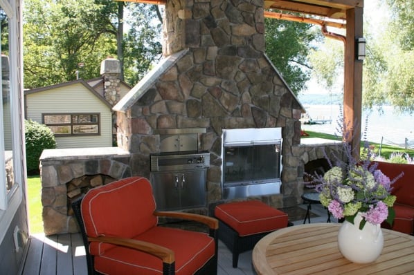 covered deck addition with stone fireplace