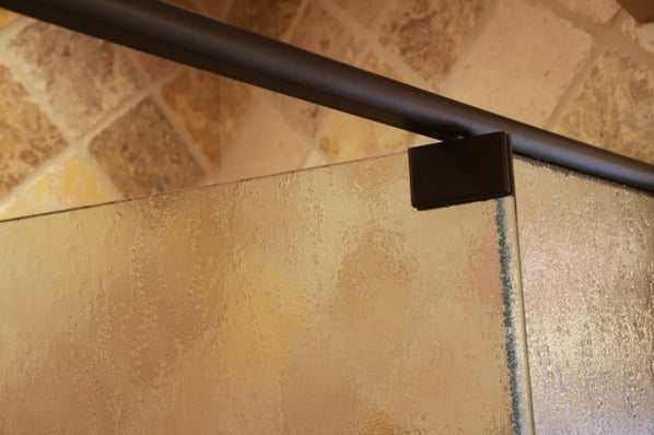 frameless textured glass shower door closeup