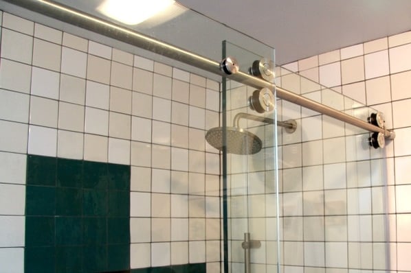 glass shower door with designer hardware