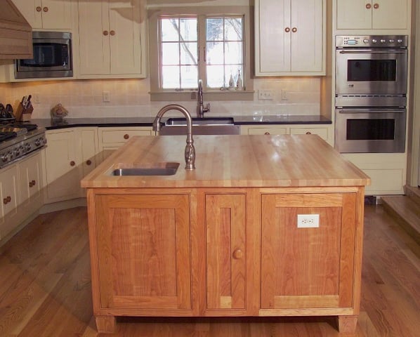 kitchen with farmhouse-style main sink and island prep sink