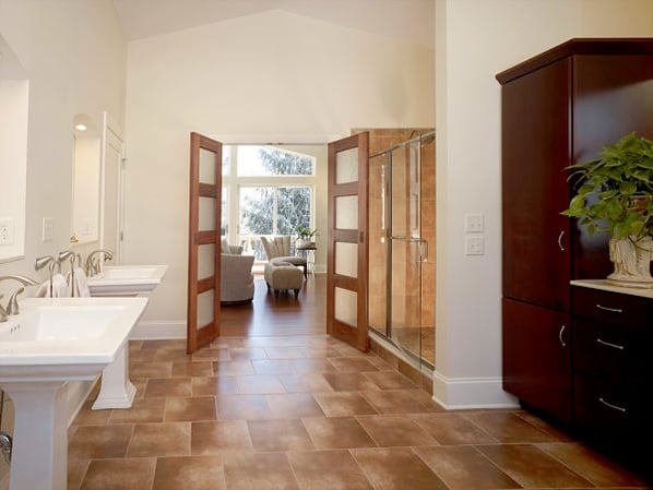master bath with pedestal sinks and walk-in shower