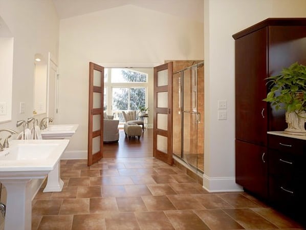 master bath with pedestal sinks and walk-in shower