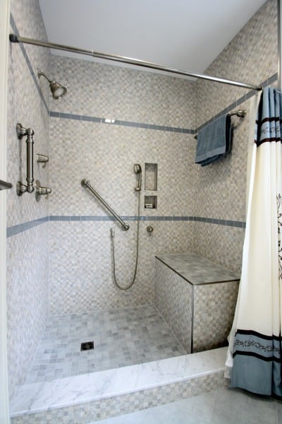 walk-in shower with custom tile base and shower curtain