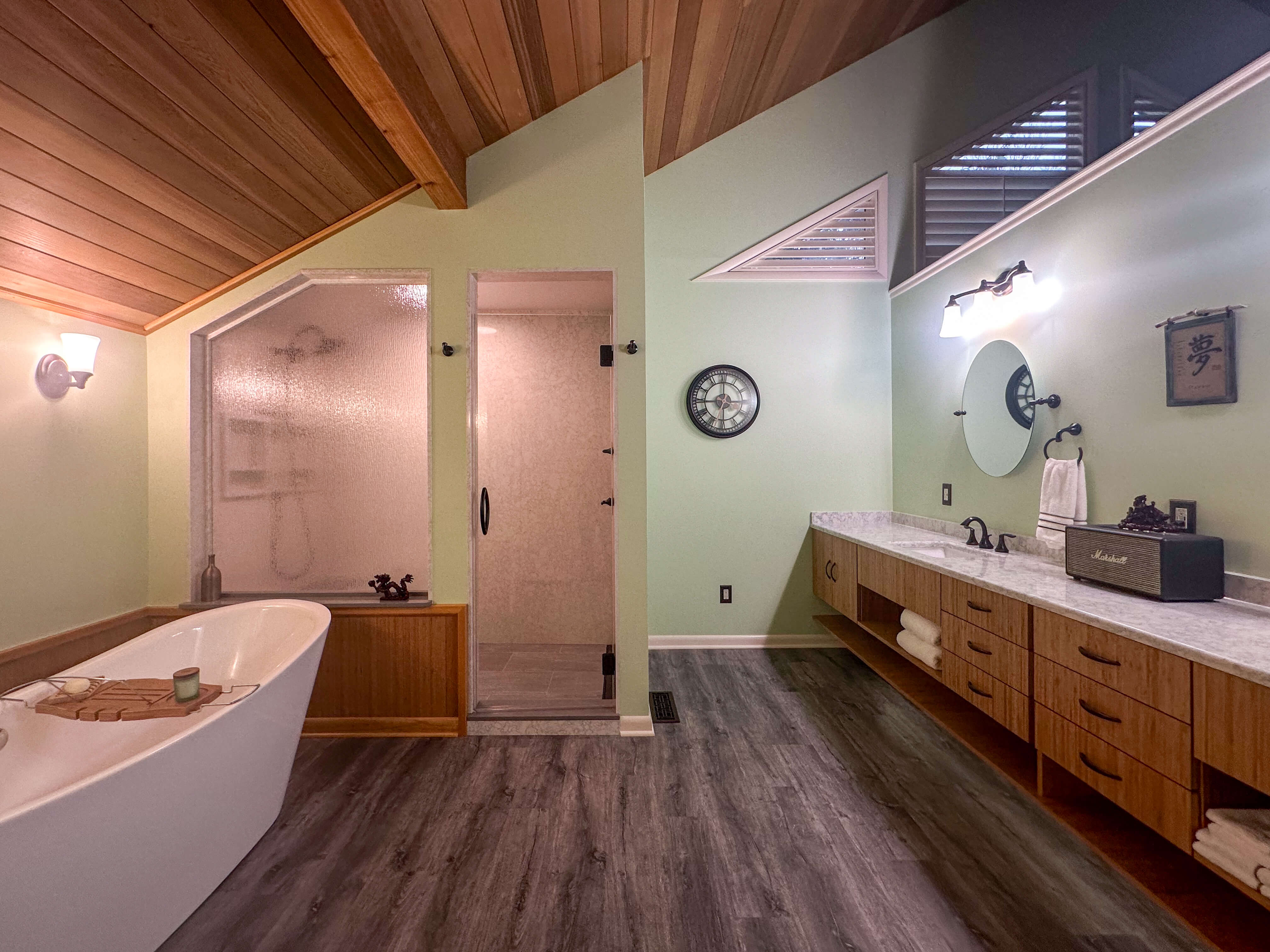 Bathroom featuring a quartz countertop vanity, quartz shower walls, wood finishes, and a durable design suited for daily use and moisture.