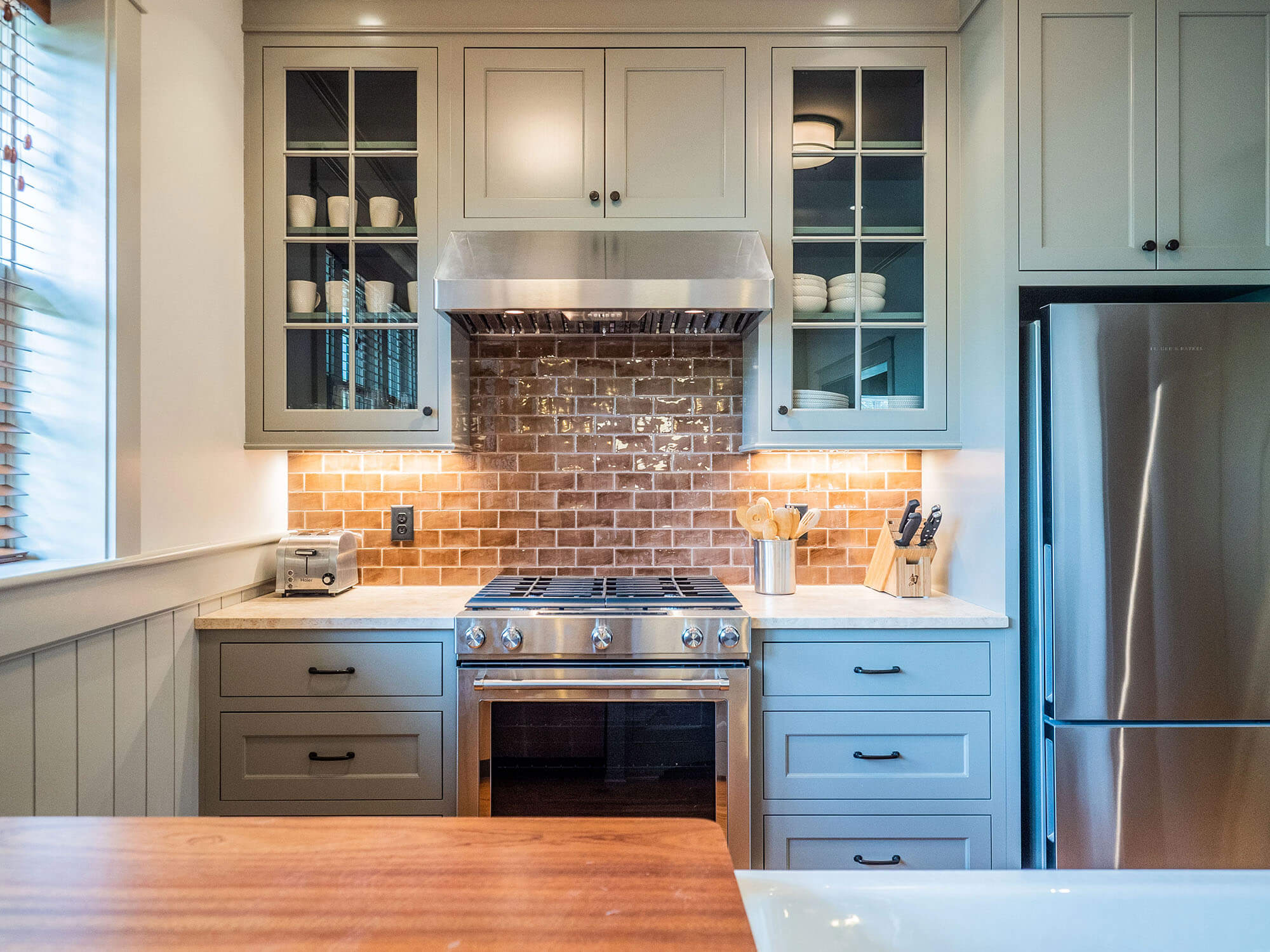 mcclurg-remodeling-kitchen-sage-cabinets-brick-backsplash