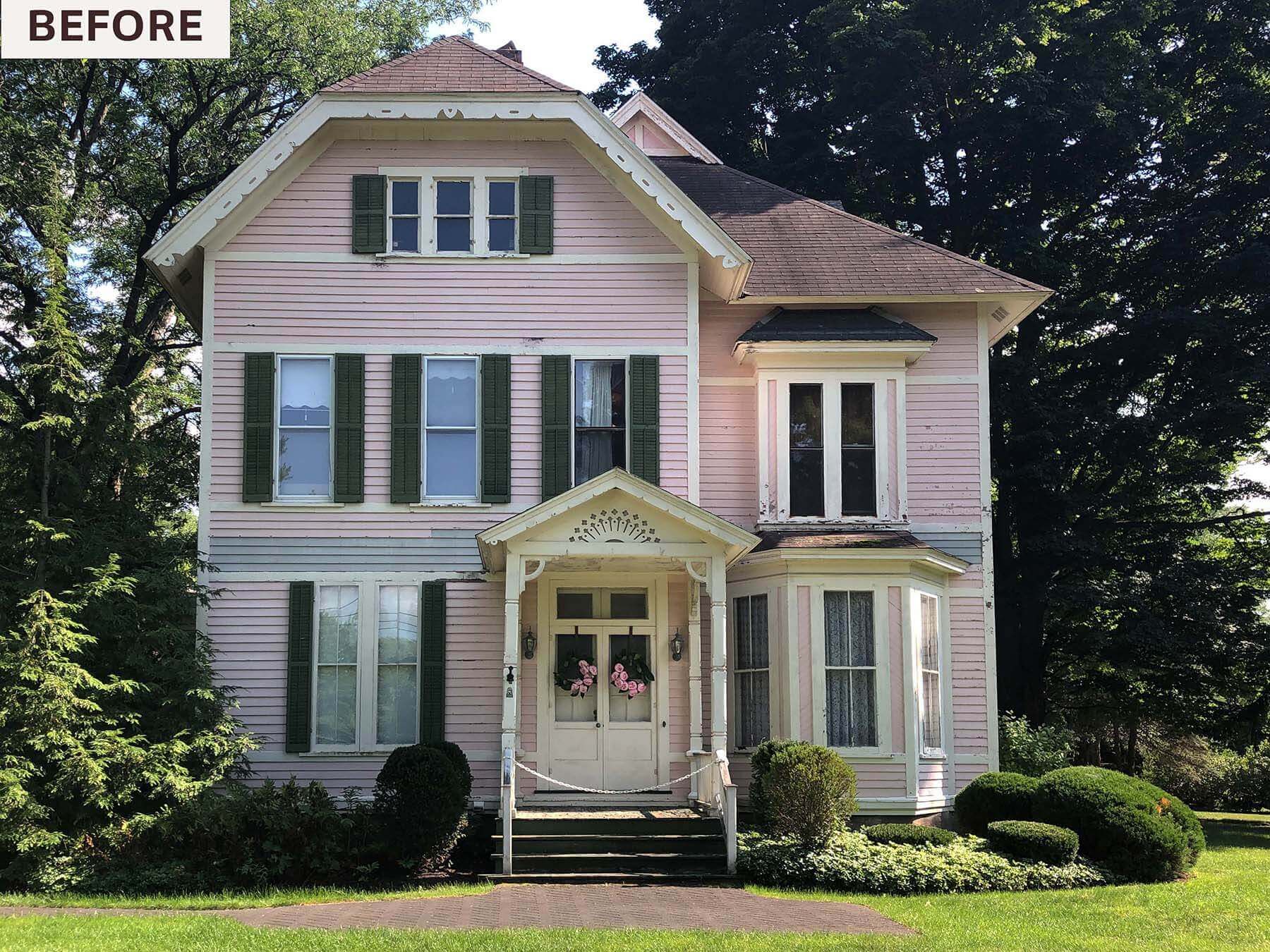 Front view of a historic late-1800s pink Victorian home in Fayetteville, NY, before window replacement by McClurg Remodeling. Features original wood windows, green shutters, and detailed trim.