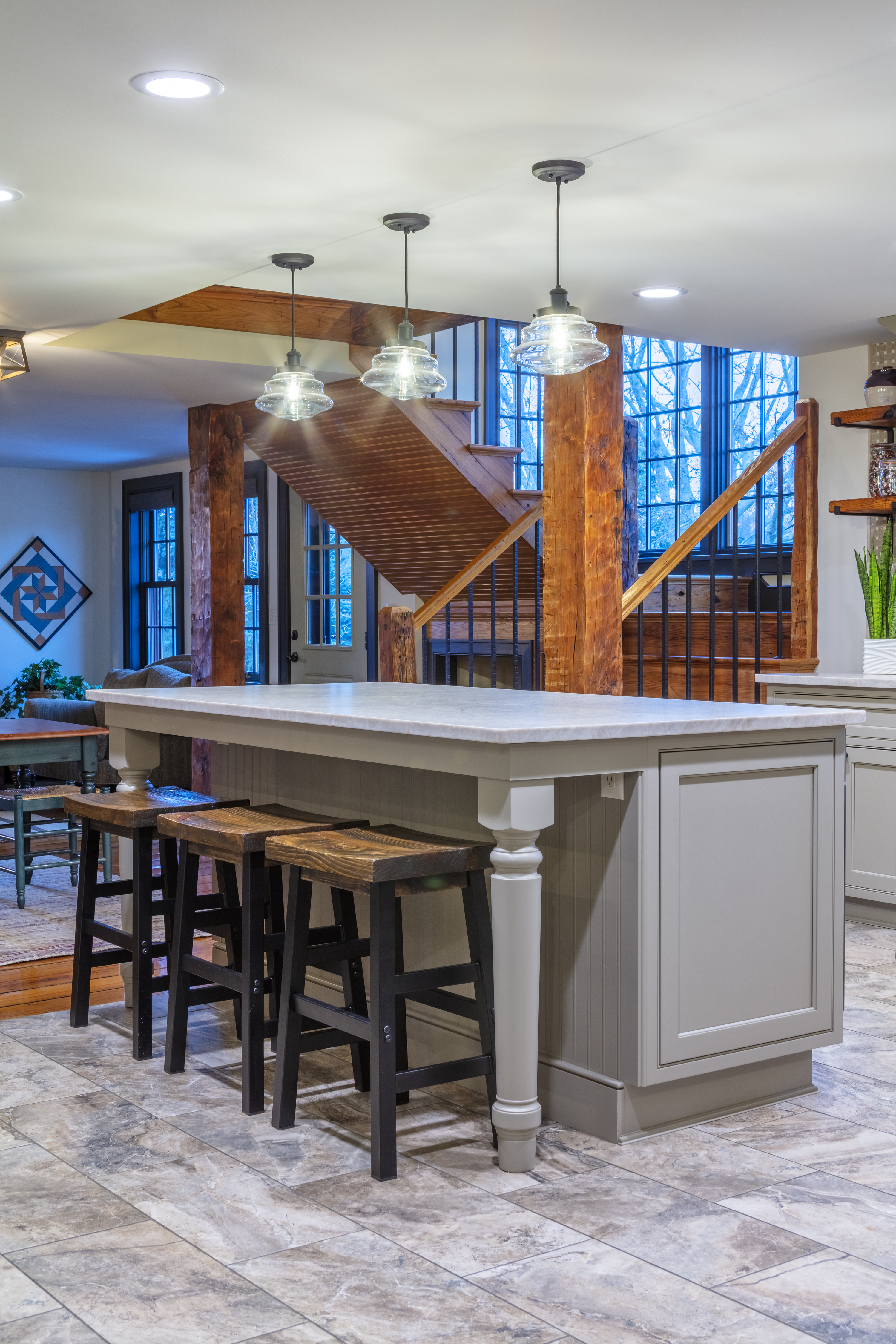 Gray kitchen island, pendant lights, granite countertops, etc.