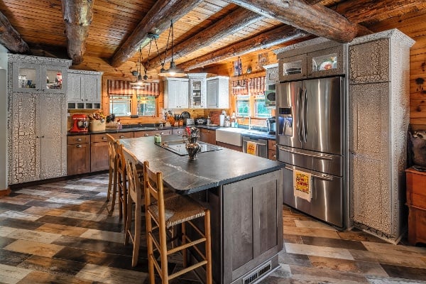 Custom speckled cabinets with multicolored wood grain floor tile.  This kitchen brings an Adirondack cabin feeling to the best room in the house!