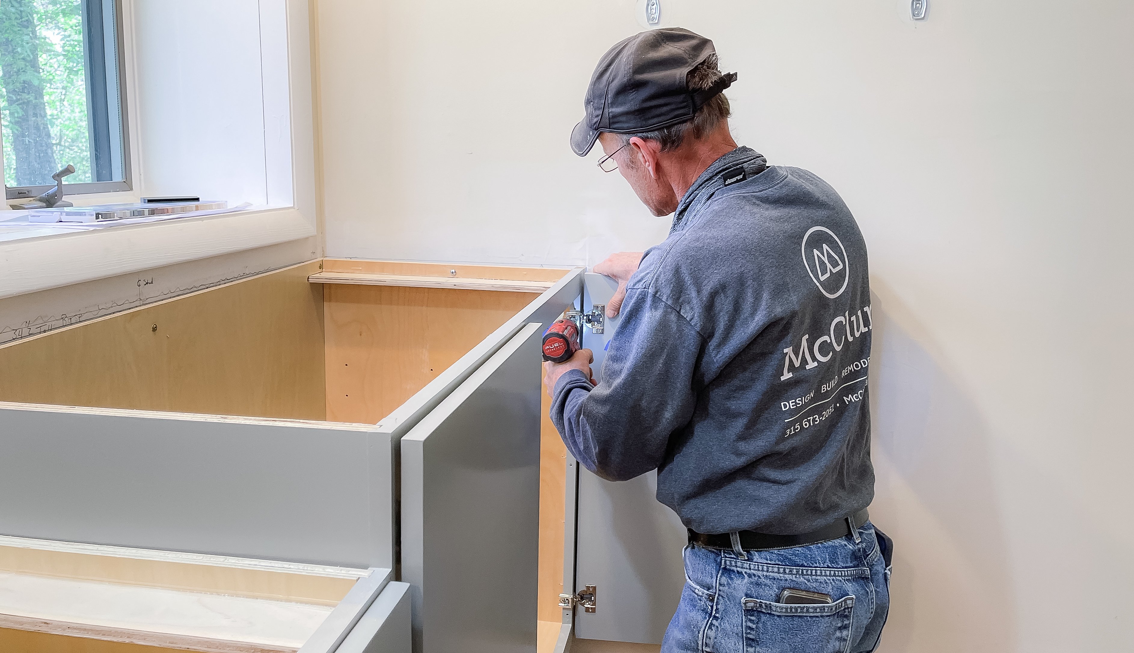 Carpenter at work, installing cabinets