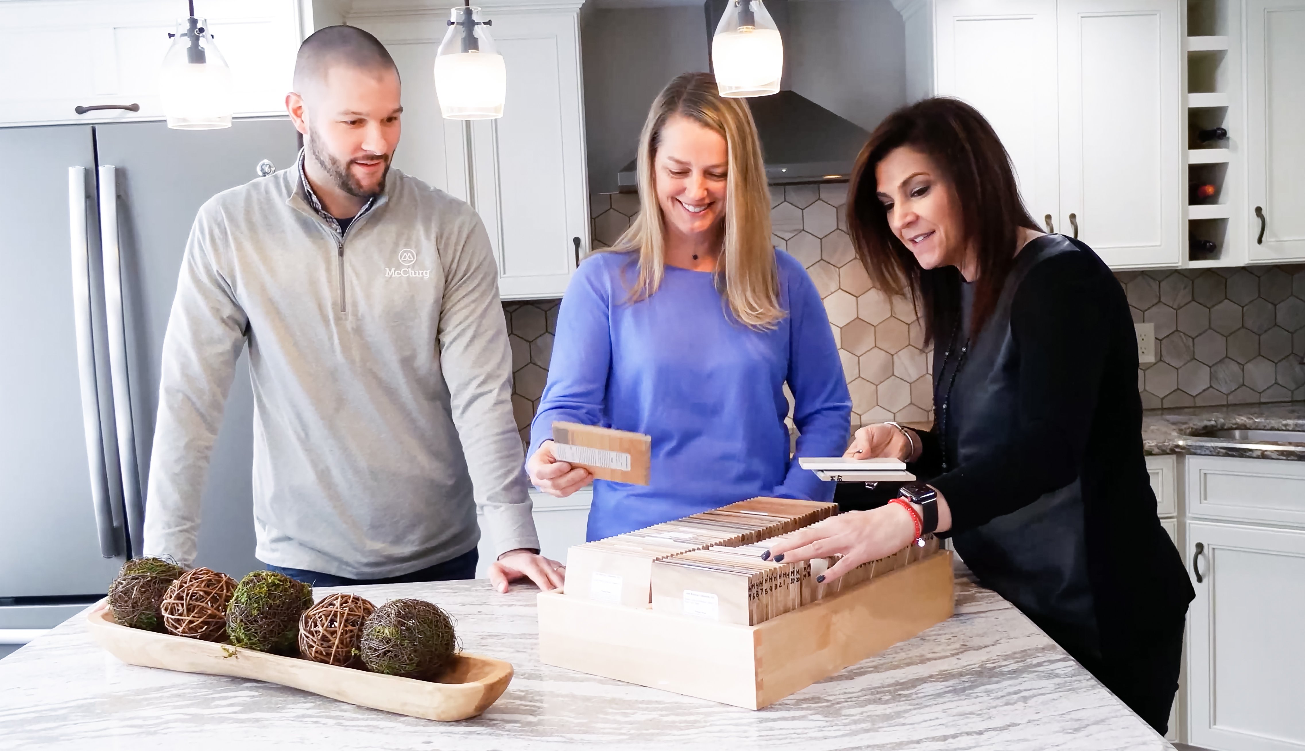 Two Project Consultants working with a client to make selections for their project