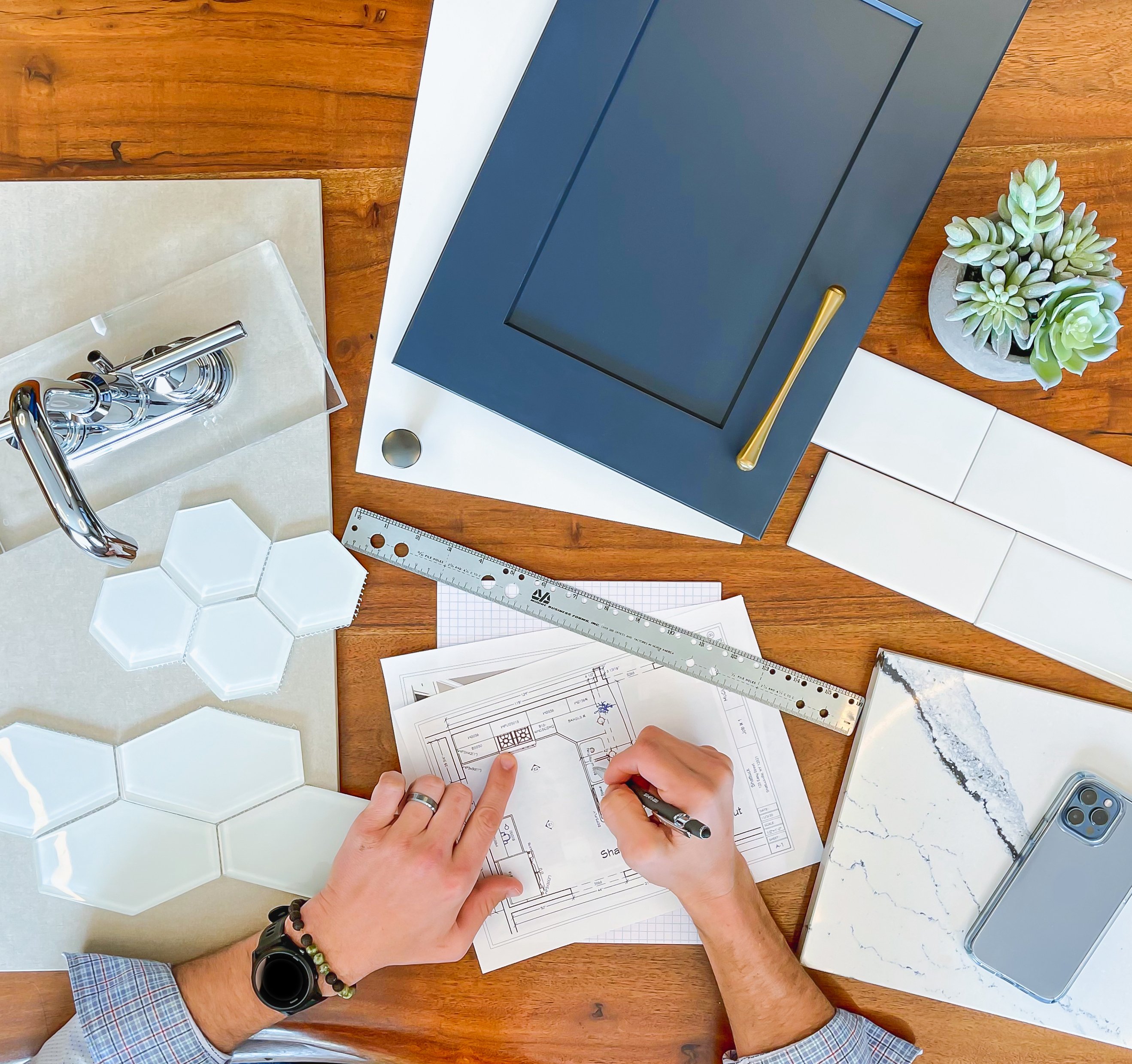 Interior design flat lay with tile, countertop, cabinet and hardware samples.