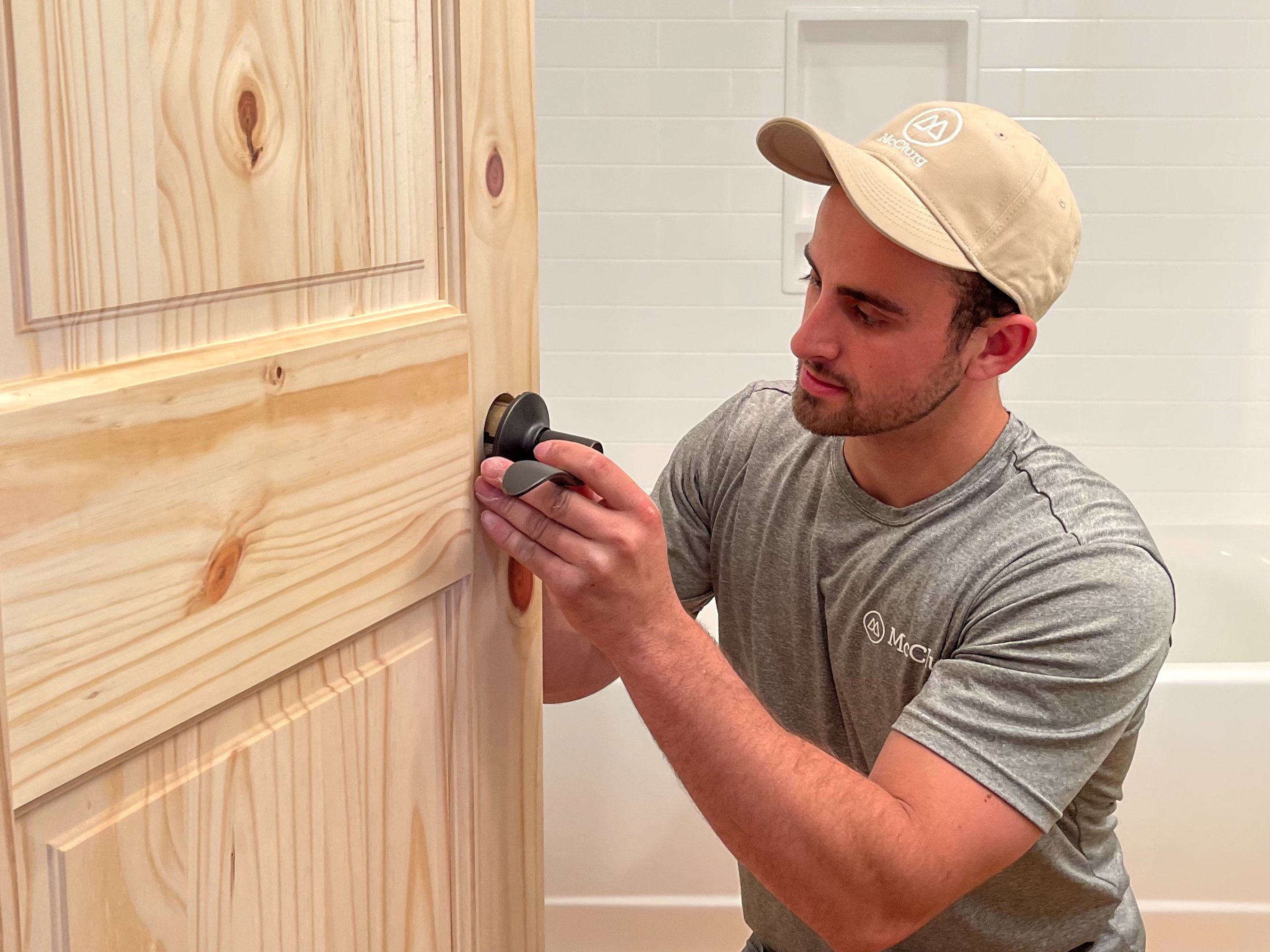 Carpenter repairing door knob