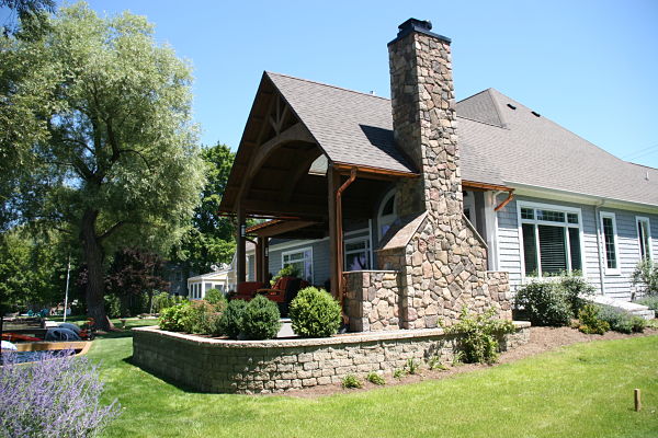 open porch addition with stone chimney
