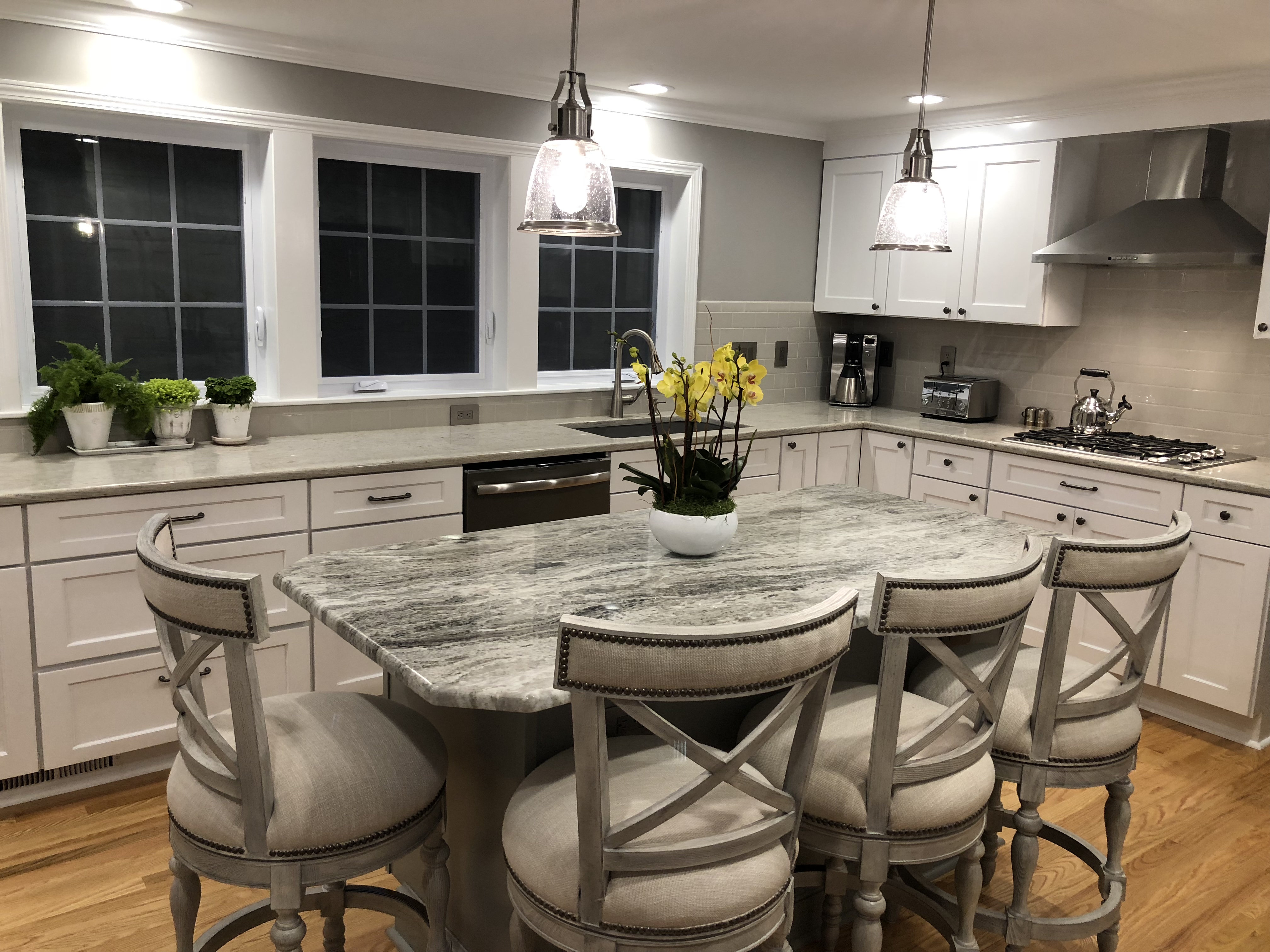 Bringing function, lighting and flow to this newly remodeled kitchen.  Bright, light colors, with plenty of seating and room to move.  