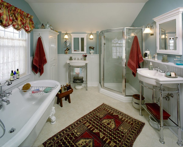 Both vibrant and calming colors help you relax and recharge. A neo-angle shower with tile walls, claw foot tub, built-in linen cabinet and two separate sink areas deliver good looks. The efficient design makes the most out of all the space in this bathroom.
