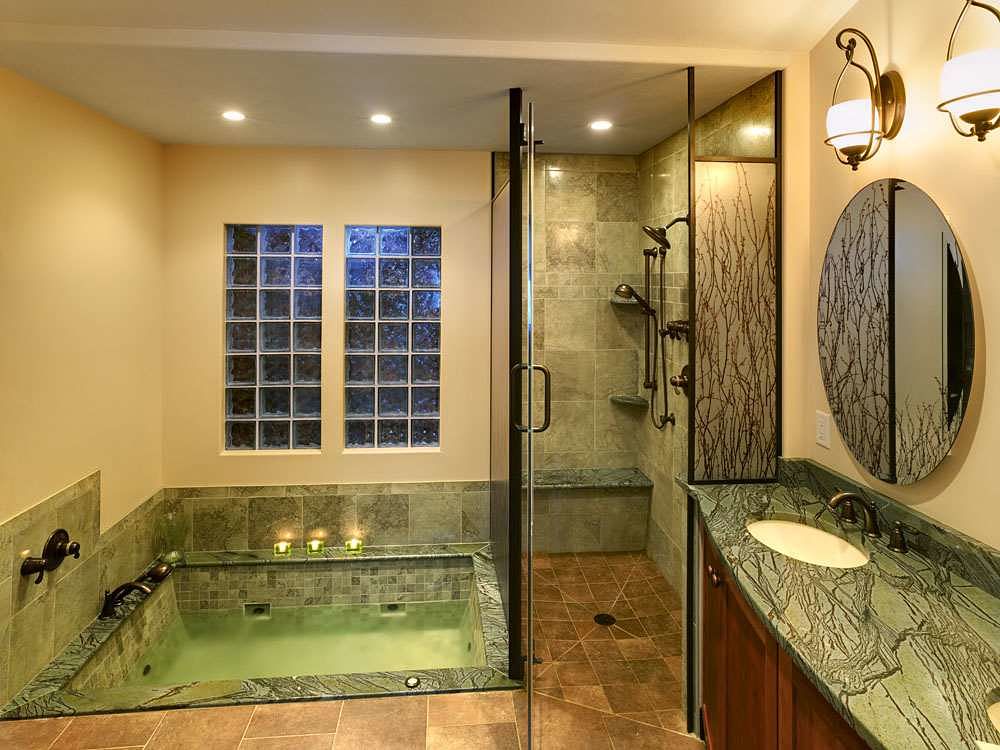 Another view of the glass shower enclosure with the door open. Note that the shower floor has no threshold.