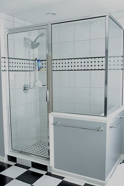 Walk-in shower with glass enclosure.
