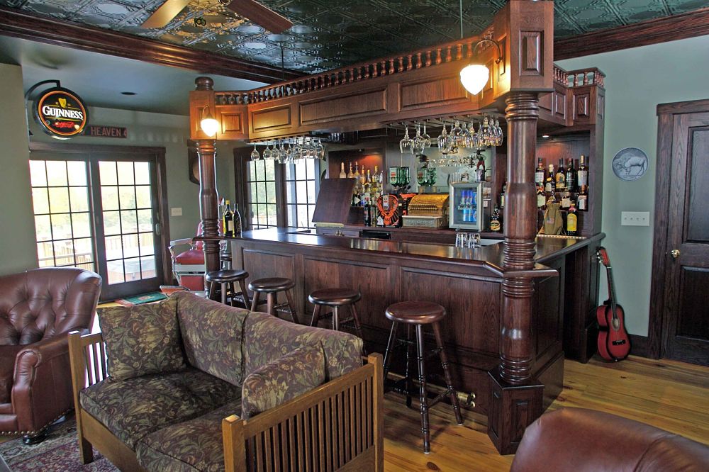 This bar was designed to meet the guidelines given to us by the owner. Some of the bars features include a sink, built in electric, a brass foot-rail, four large hand-turned columns and over 200 hand turned spindles on the top rail. The bar room also includes a tin ceiling with its own bathroom and pool room off to the sides.