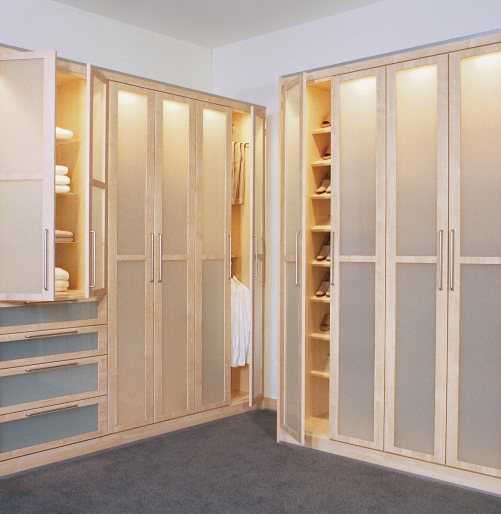 This custom closet features doors and drawers with translucent panels and built-in lighting.