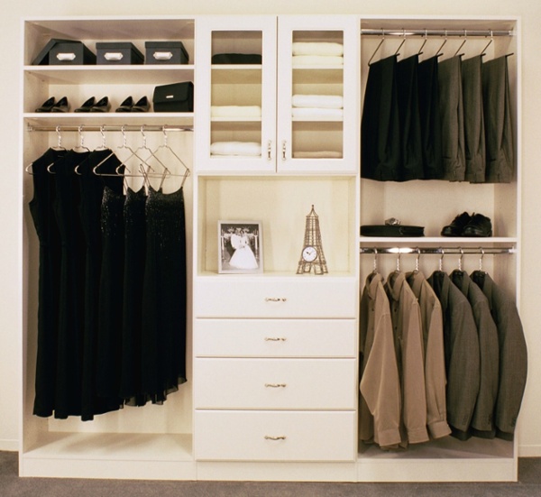 Closet storage system with multiple rods, shelves, and drawers.