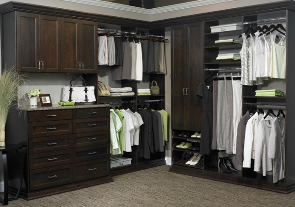 This custom walk-in closet features a ten drawer dresser with a granite countertop.