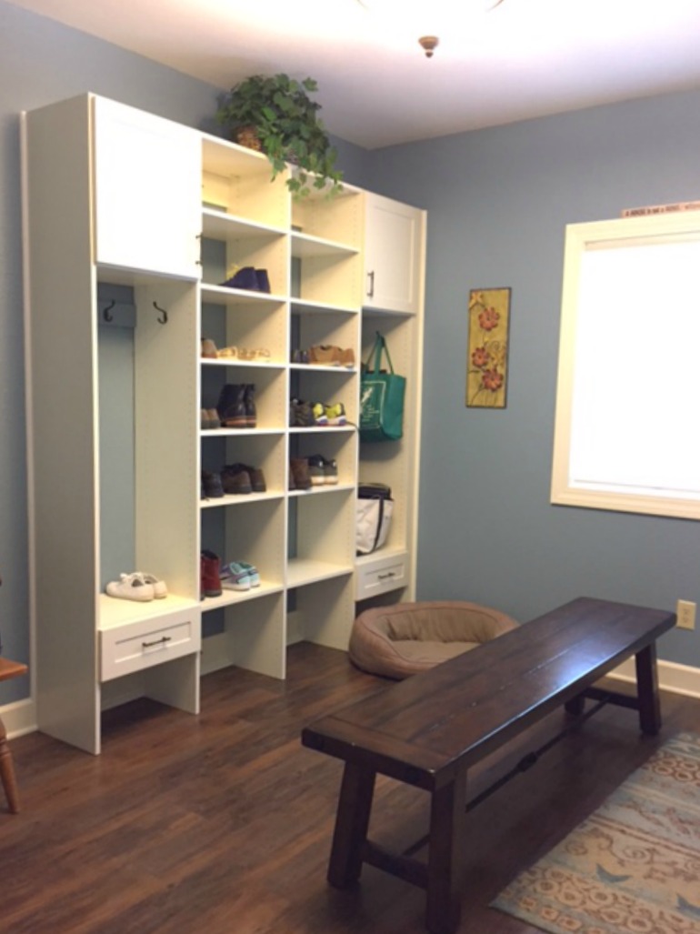 This bright and inviting mudroom addition includes built-in shelving and locker space with a large bench for family members.